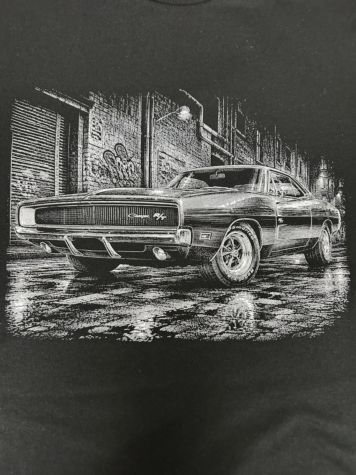 Close-up of the 1970 Dodge Charger R/T print on a black t-shirt
