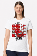 Woman wearing a white t-shirt with an It's Game Day Y'all football and bow print