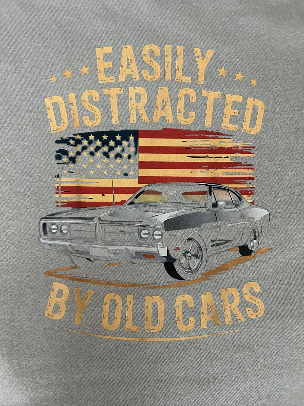 Close-up of the Easily Distracted By Old Cars print on a gravel grey t-shirt
