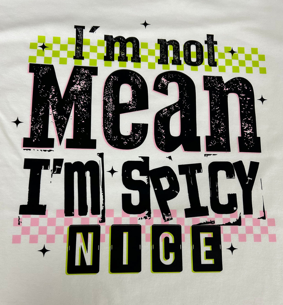 Close-up of the I'm Not Mean I'm Spicy Nice print on a white t-shirt