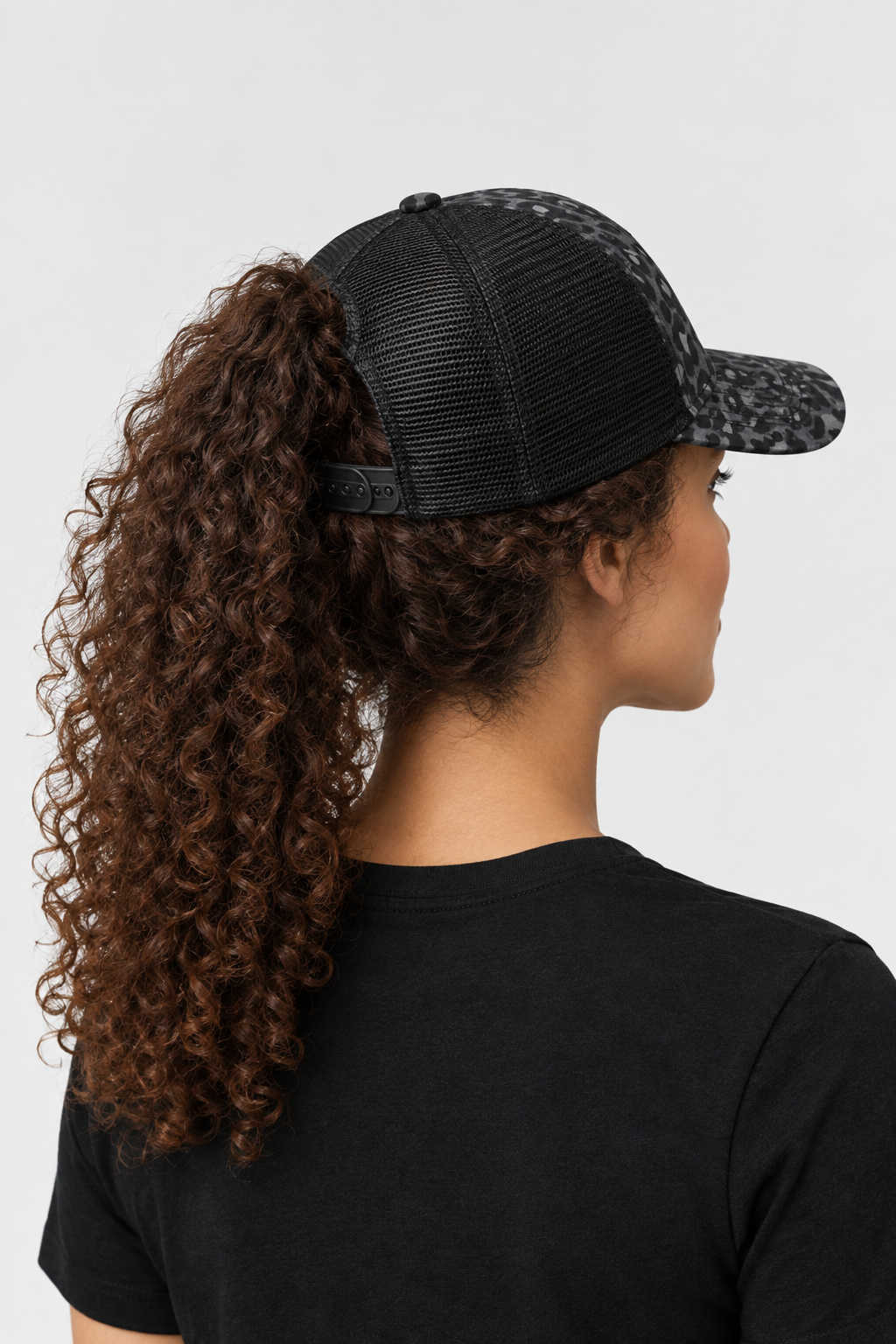 Back view of Worthy Infinity Her ponytail trucker hat showing the black mesh, ponytail opening, and snapback closure