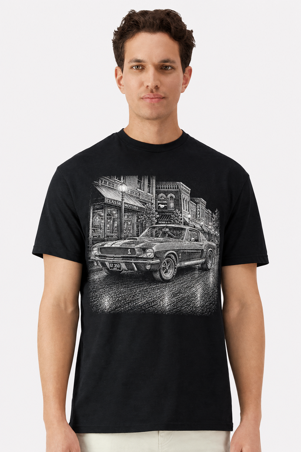 Model wearing a black t-shirt with a detailed 1966 Shelby Mustang GT350 main street print