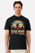 Model wearing a black t-shirt with a retro sunset Believe In Yourself Sasquatch print