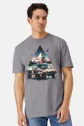 Model wearing a gravel grey t-shirt with a watercolor Pontiac Firebird Trans Am mountain print