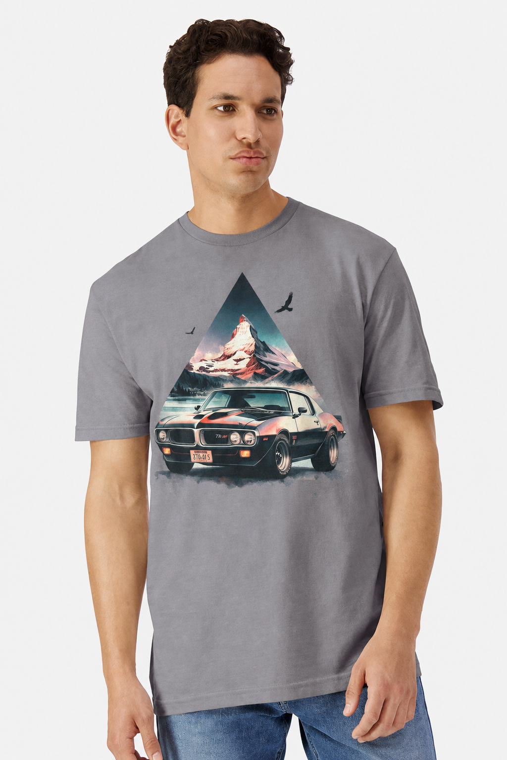 Model wearing a gravel grey t-shirt with a watercolor Pontiac Firebird Trans Am mountain print