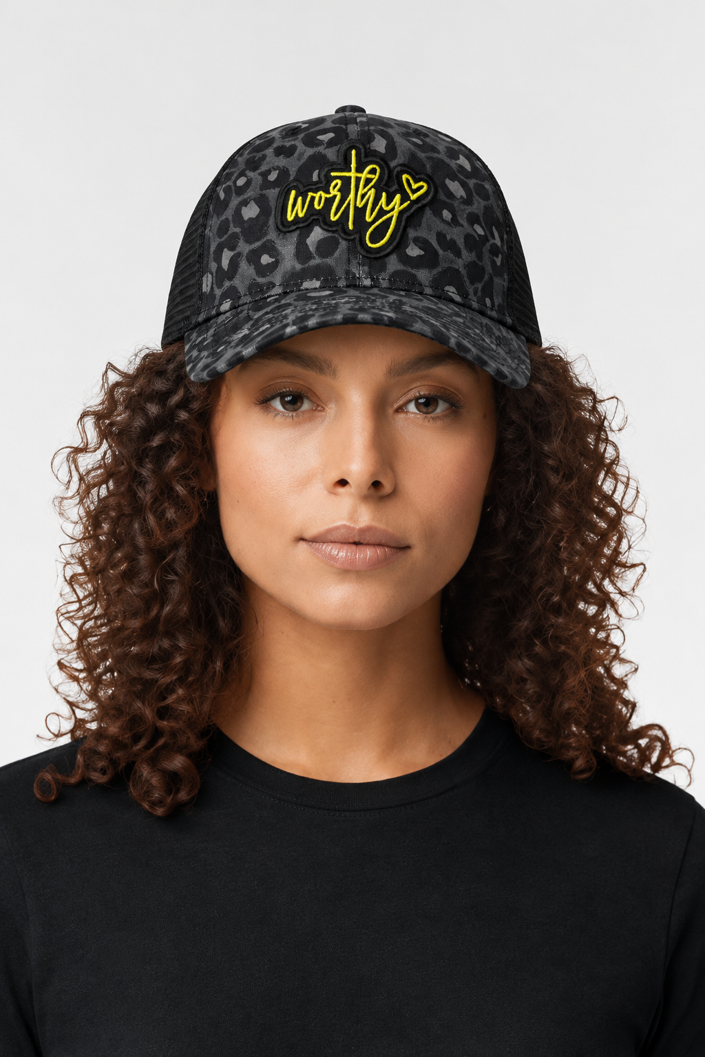Worthy Infinity Her ponytail trucker hat with black and grey leopard print and black mesh on model