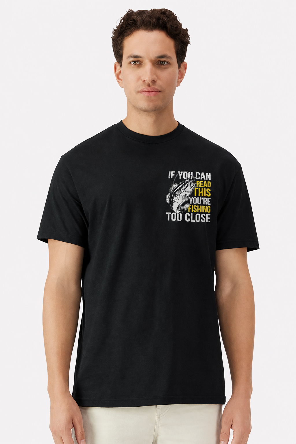Model wearing a black t-shirt with a small left chest Fishing Too Close pocket print