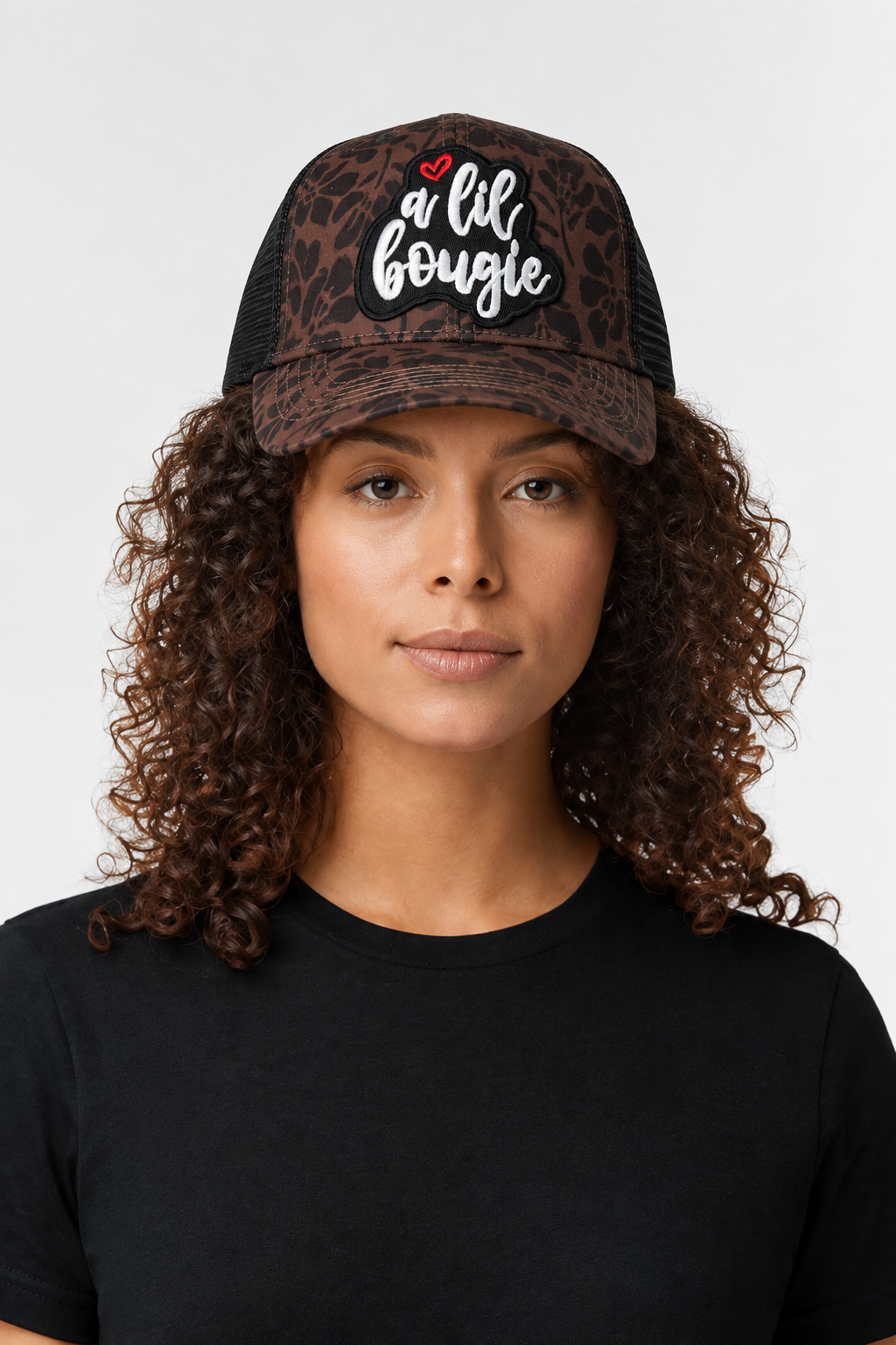 A Lil Bougie Infinity Her ponytail trucker hat with brown floral leopard print and black mesh on model