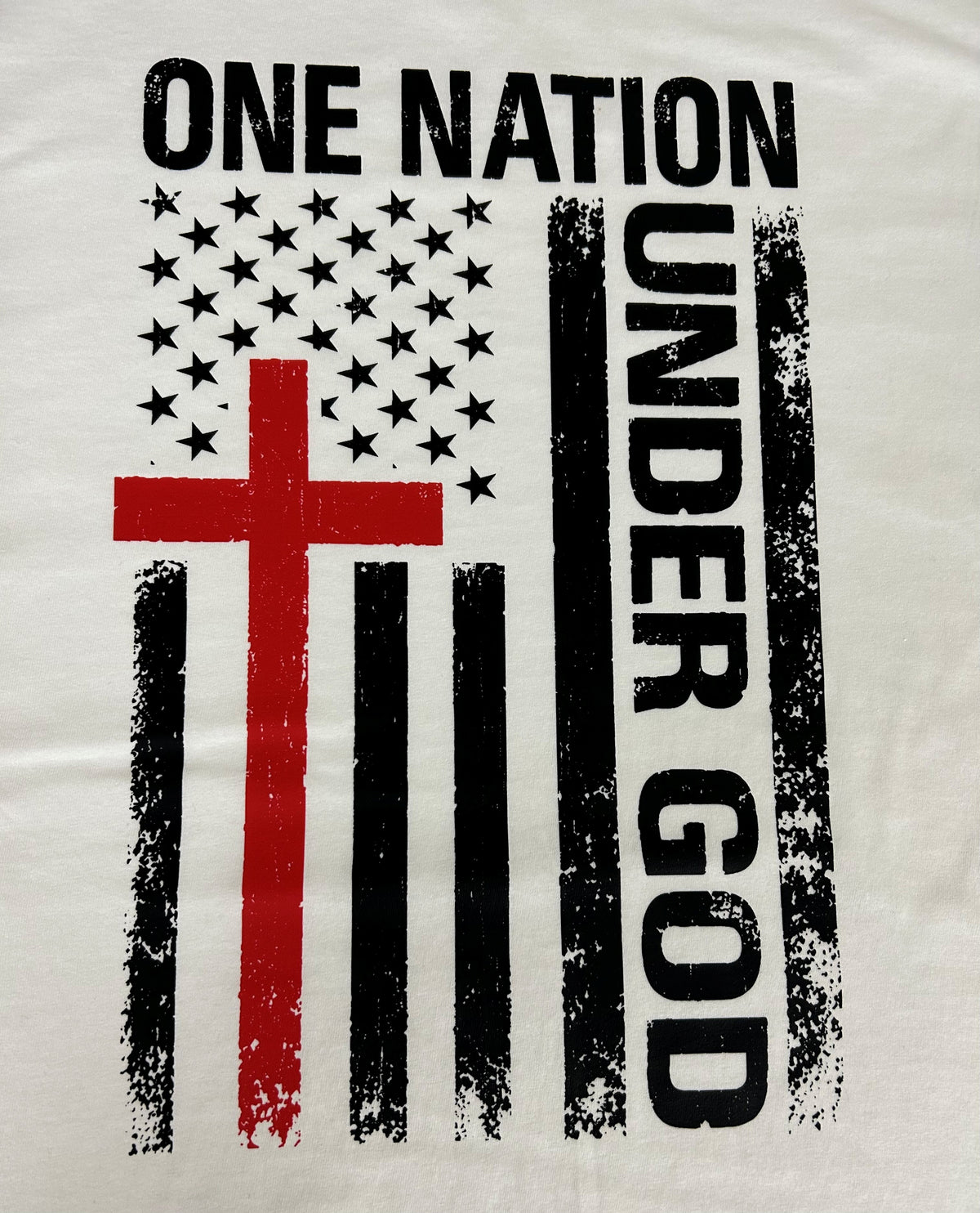 Close-up of the One Nation Under God flag and cross print on a white t-shirt