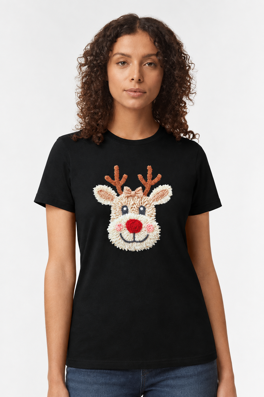 Woman wearing a black t-shirt with a chenille-look Christmas reindeer face print
