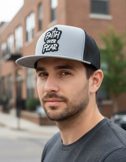 Faith over Fear cloth patch on a black/gray Yupoong Classic flat bill trucker hat